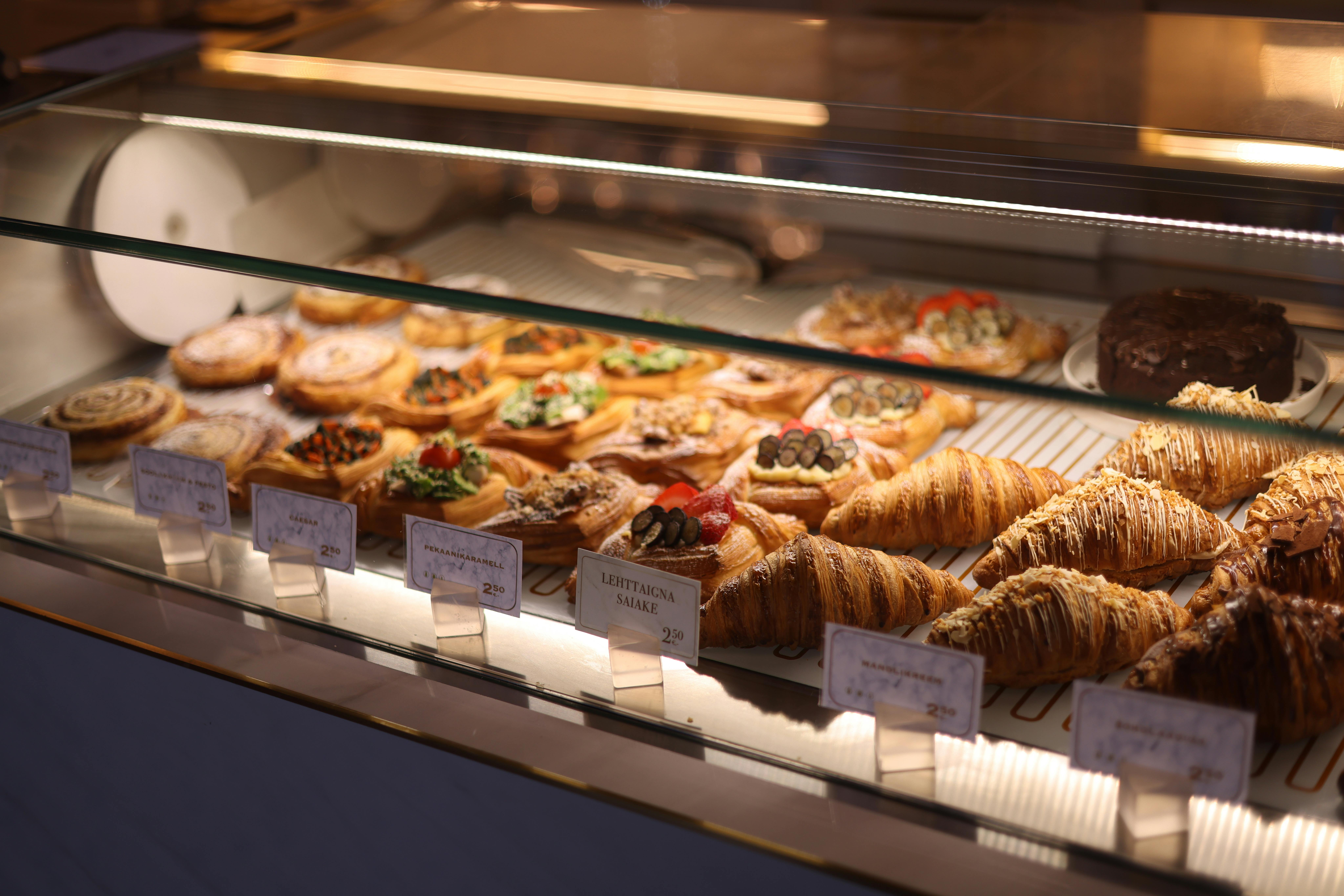 Freshly baked pastries on display behind glass.